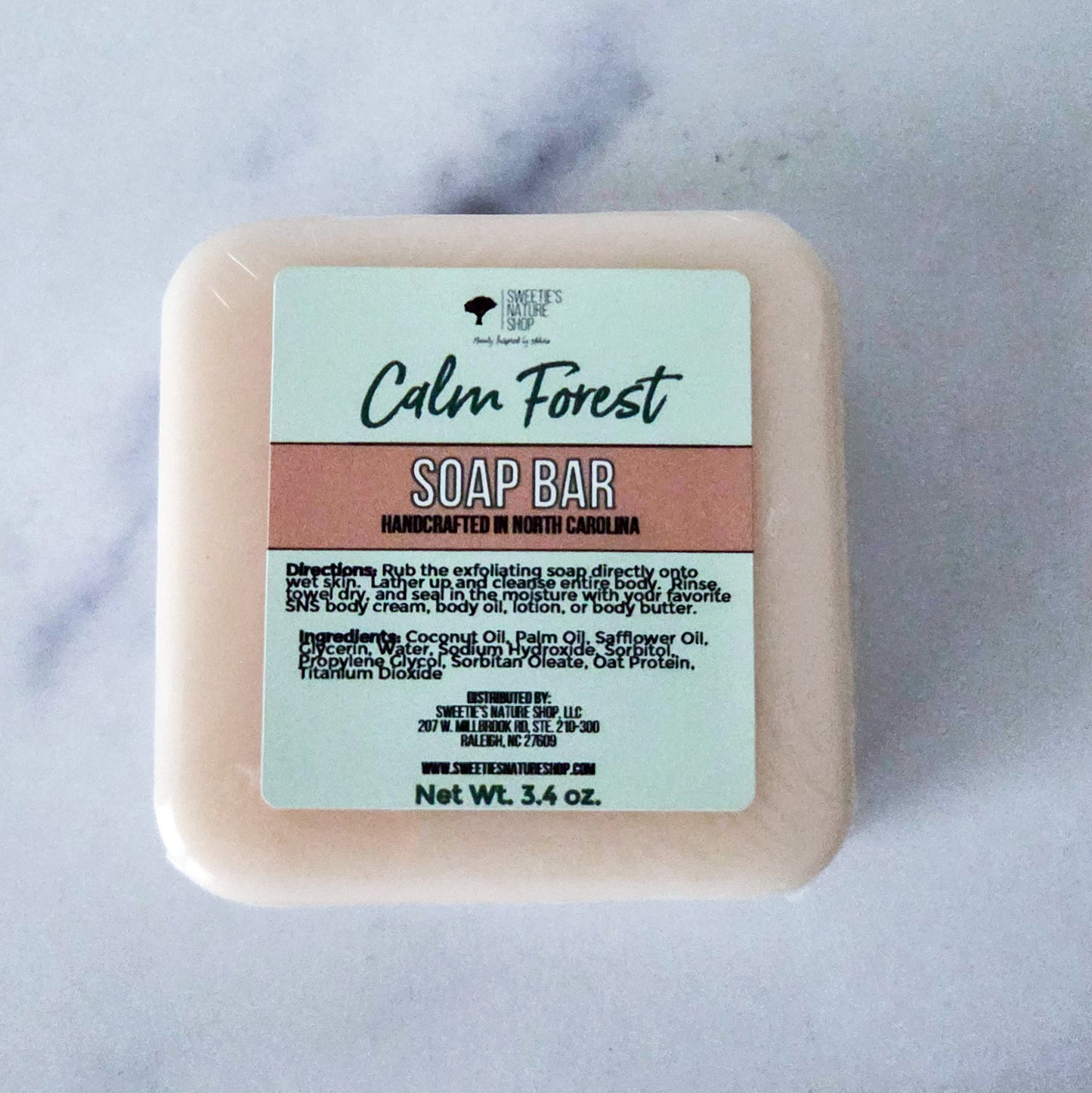 Square soap bar with rounded edges in a warm tan color — Calm Forest Soap Bar by Sweetie's Nature Shop, with notes of lemon peel, grapefruit, eucalyptus, white cedar, and Siberian fir
