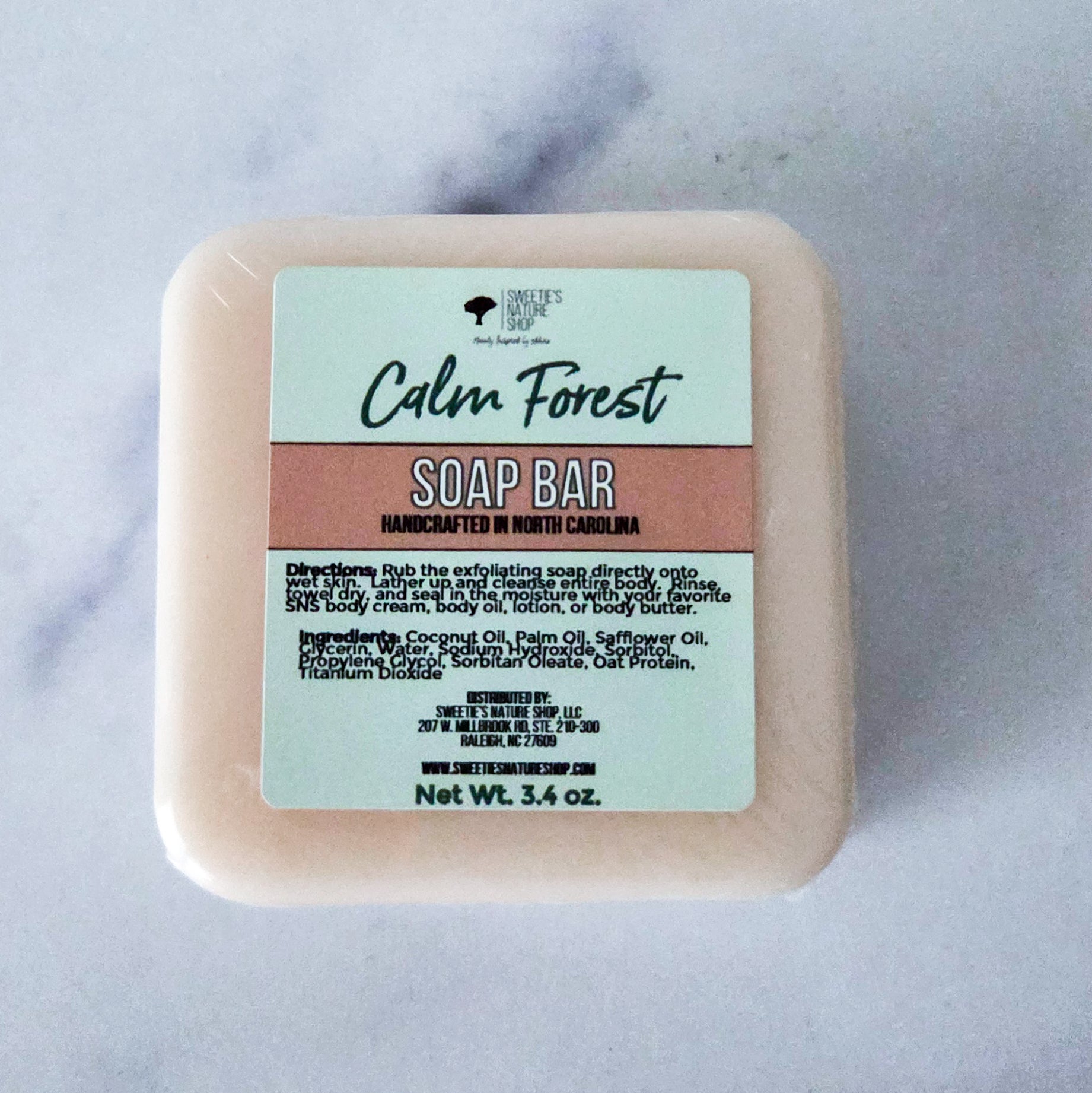 Square soap bar with rounded edges in a warm tan color — Calm Forest Soap Bar by Sweetie's Nature Shop, with notes of lemon peel, grapefruit, eucalyptus, white cedar, and Siberian fir