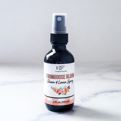 Room and linen spray bottle labeled 'Farmhouse Bloom' on a white background