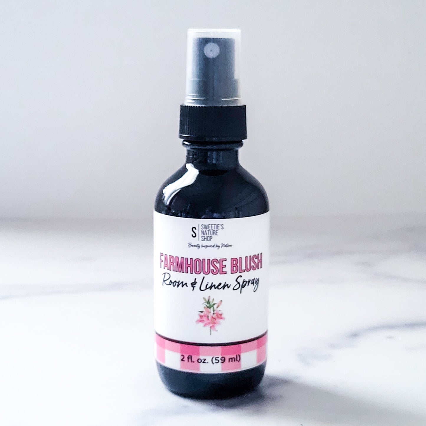 Bottle of Farmhouse Blush Room & Linen Spray on a white background