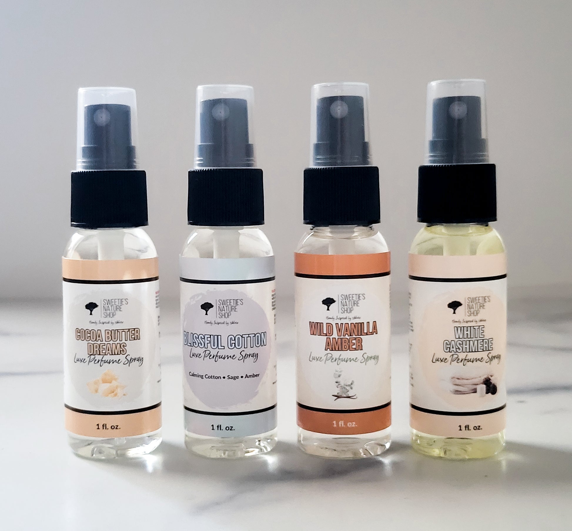 Four small perfume sprays 